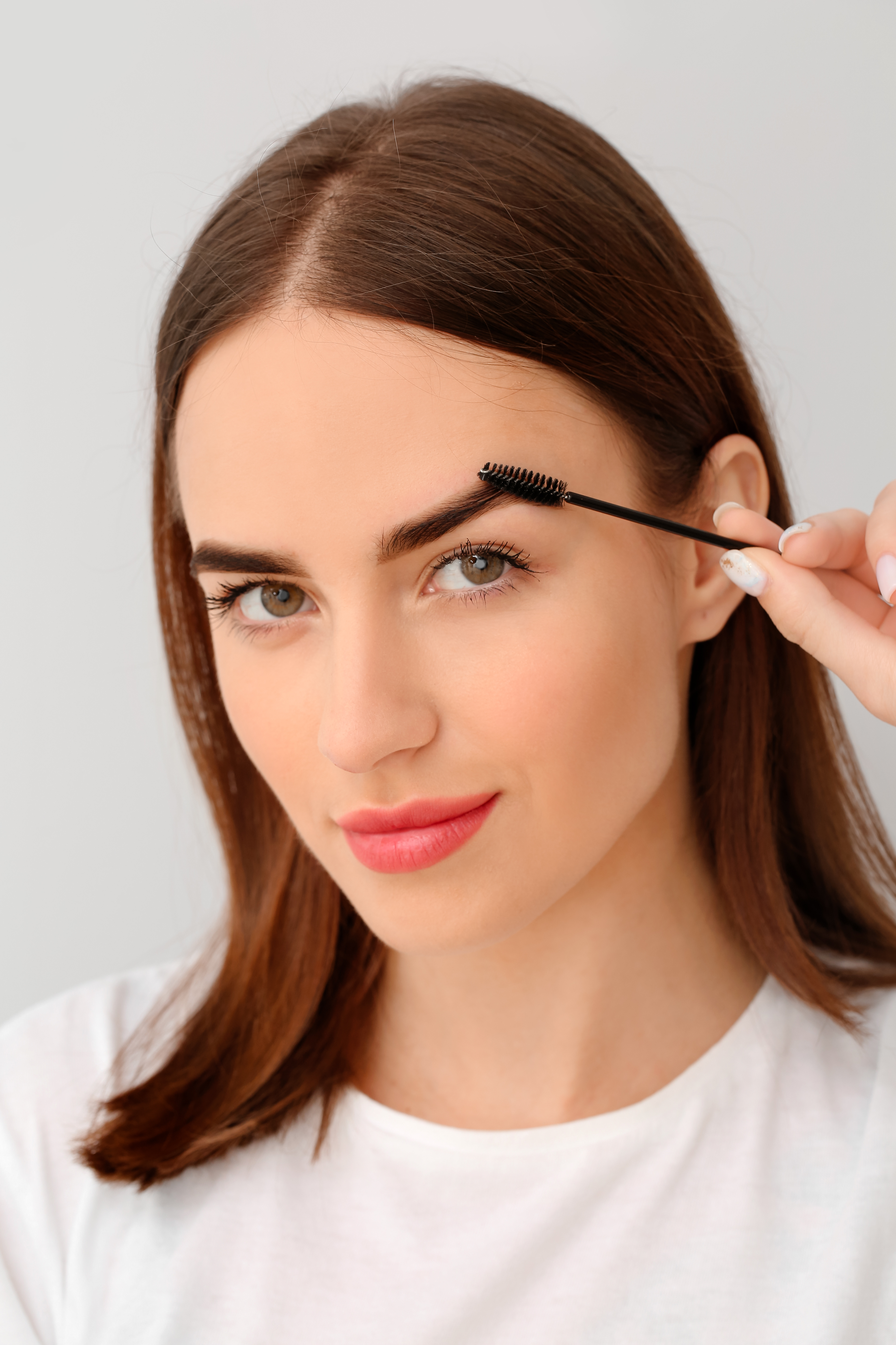 A woman getting her eyebrows waxed in North Utica, NY from Cutting Crew Hair Salon.
